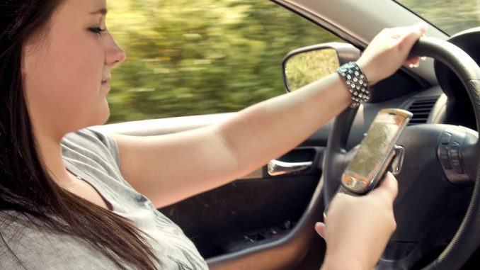 15865-a-teen-girl-texting-while-driving-pv